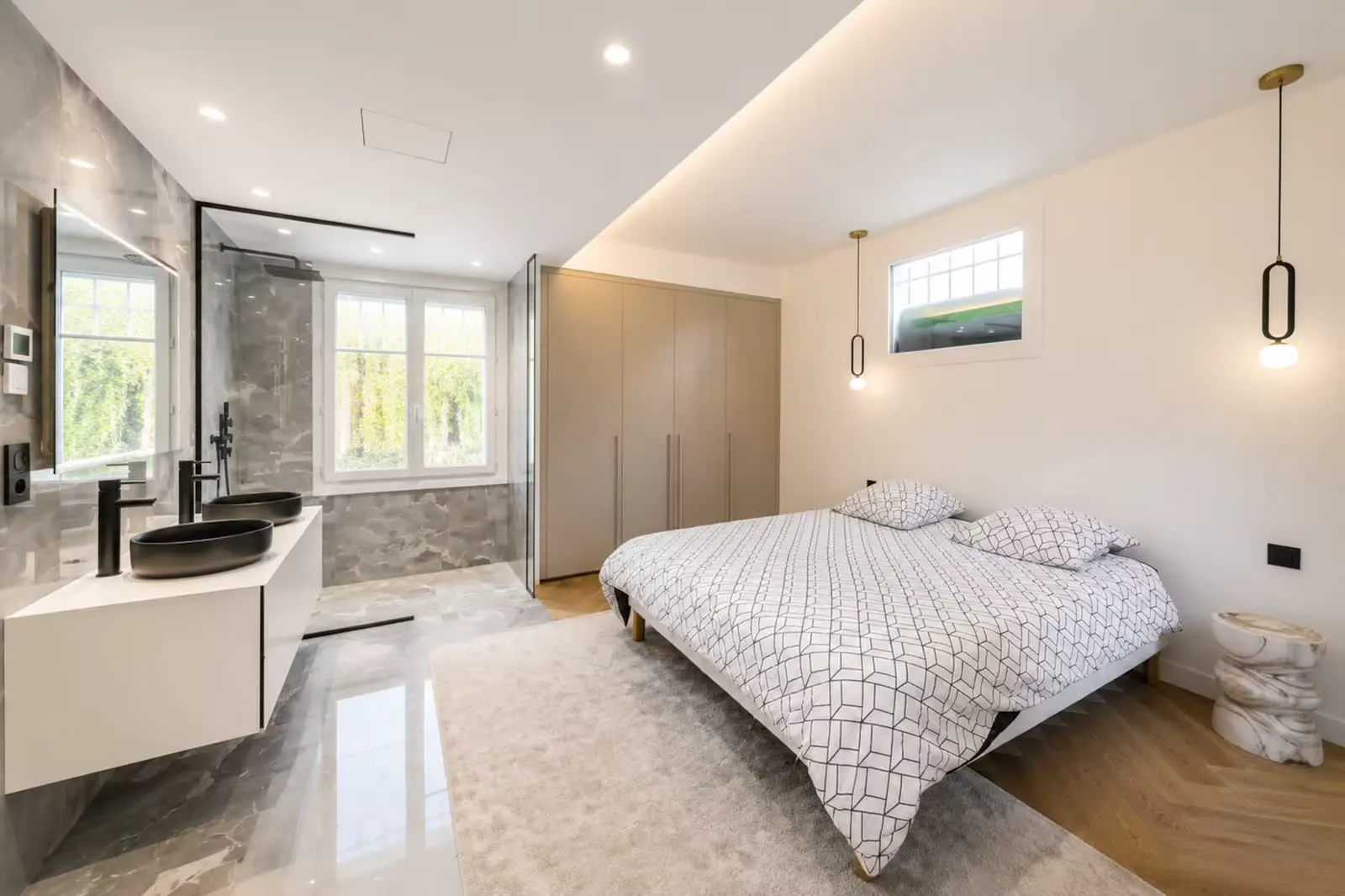 Bedroom with open grey marble ensuite bath