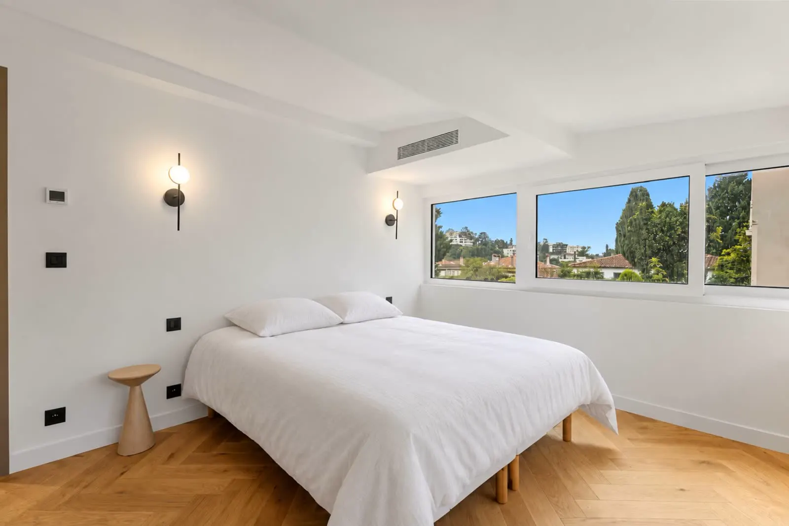 Bright bedroom with rooftop skyline view
