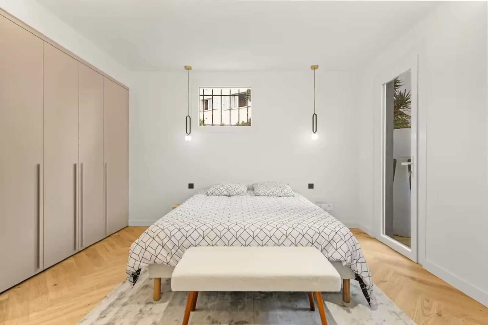 Second bedroom with beige built-in wardrobes