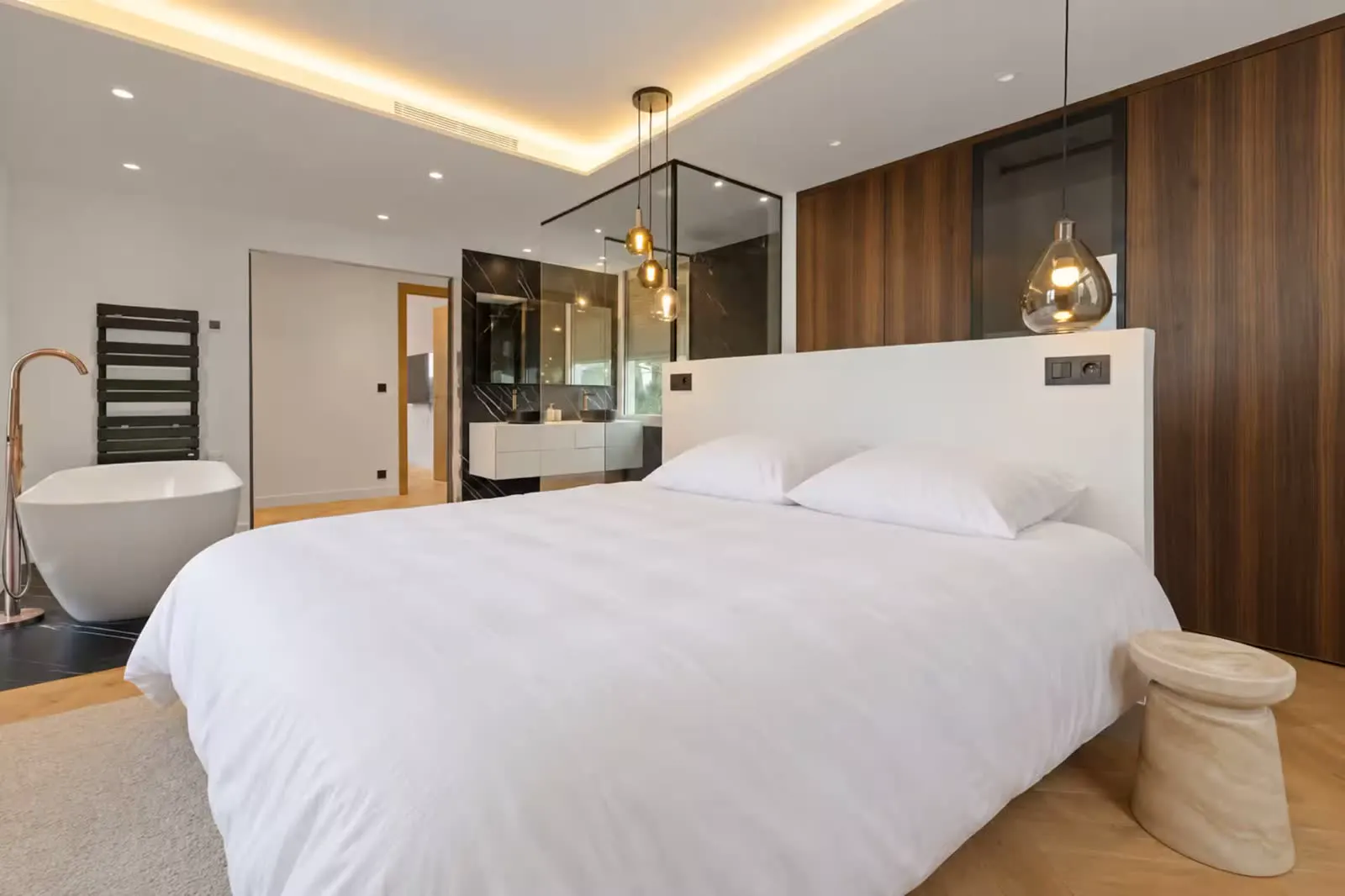 Bedroom with wood panelling and freestanding tub