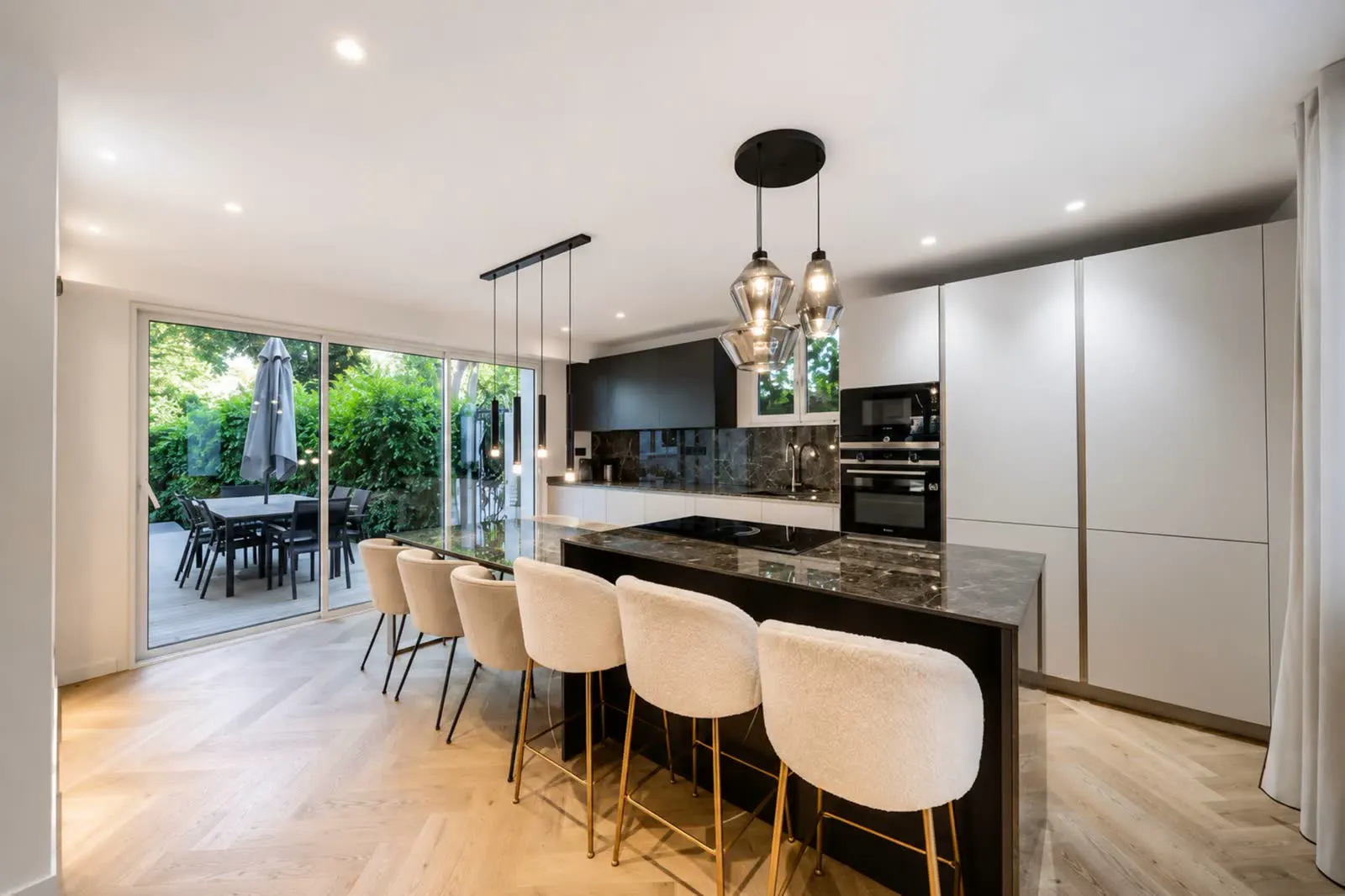 Open kitchen with marble island and bar seating
