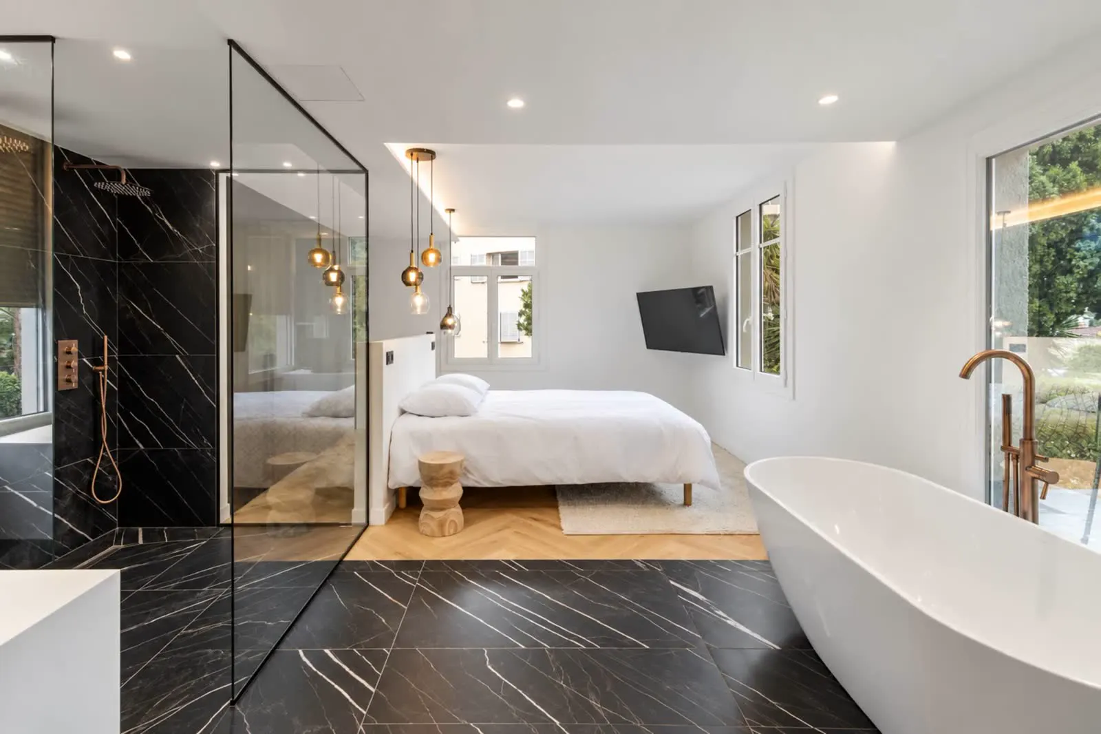 Master suite with open bathroom and freestanding tub