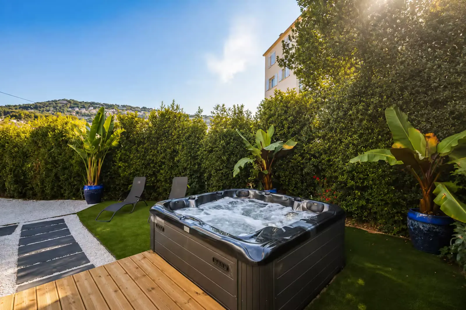Jacuzzi with sun loungers overlooking the hills